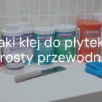 A neatly arranged selection of tile adhesives and ceramic tiles on a clean work surface, with trowel and gloves, bright and professional lighting, realistic.